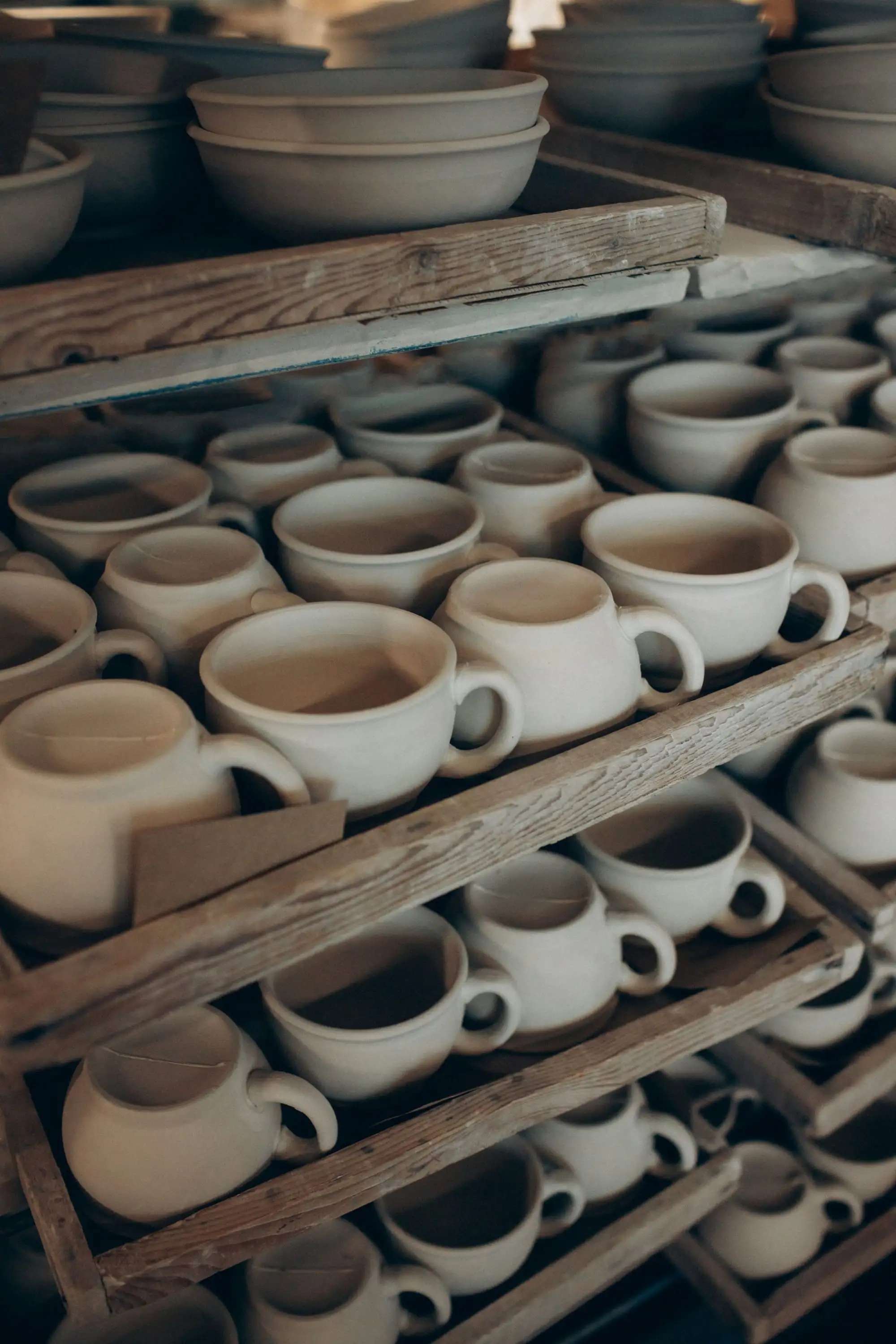 Ceramic cups and bowls on shelves