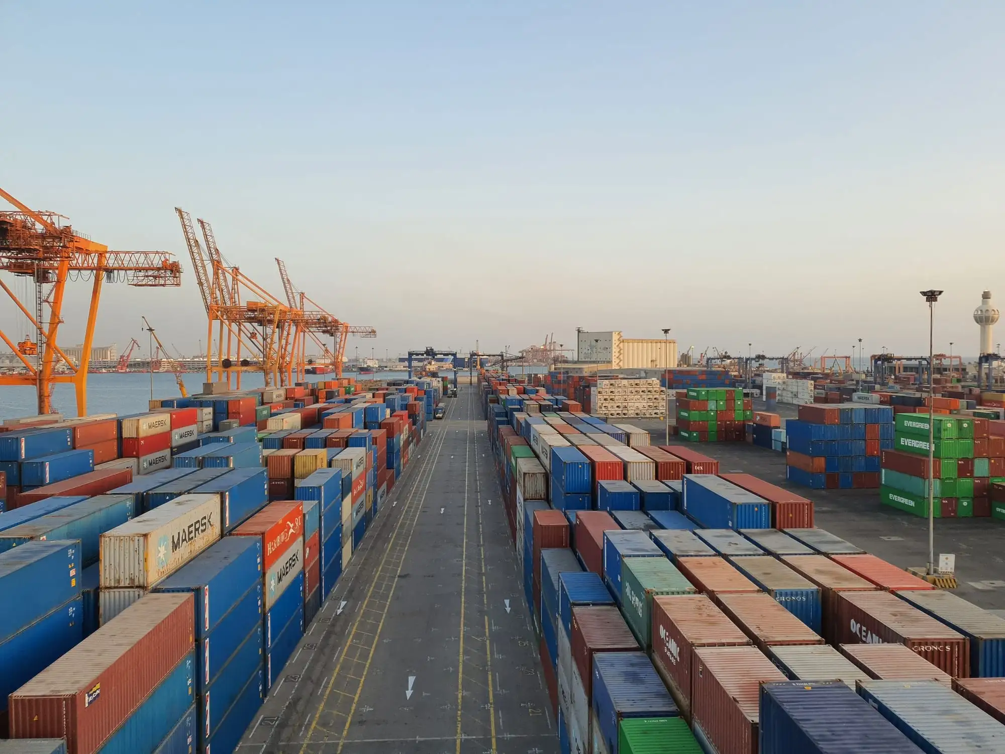 Container port at sunrise with cranes and stacked containers